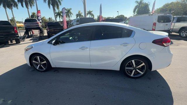 2017 Snow White Pearl /Black Kia Forte (3KPFL4A80HE) with an 4 2.0 L engine, Automatic transmission, located at 27610 S Dixie Hwy, Homestead, FL, 33032, (305) 749-2348, 25.510241, -80.438301 - KBB.com 10 Most Awarded Brands. Only 79,834 Miles! Scores 33 Highway MPG and 25 City MPG! This Kia Forte delivers a Regular Unleaded I-4 2.0 L/122 engine powering this Automatic transmission. SNOW WHITE PEARL, CARPETED FLOOR MATS, BLACK, LEATHER SEAT TRIM.*This Kia Forte Comes Equipped with These Op - Photo#1