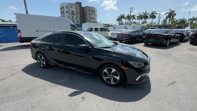 2019 Black Honda Civic Sedan (19XFC2F67KE) with an 4 2.0 L engine, Variable transmission, located at 27610 S Dixie Hwy, Homestead, FL, 33032, (305) 749-2348, 25.510241, -80.438301 - Boasts 38 Highway MPG and 30 City MPG! This Honda Civic Sedan boasts a Regular Unleaded I-4 2.0 L/122 engine powering this Variable transmission. Window Grid Antenna, Wheels: 16 w/Full Covers, VSA Electronic Stability Control (ESC).*This Honda Civic Sedan Comes Equipped with These Options *Trunk Rea - Photo#7