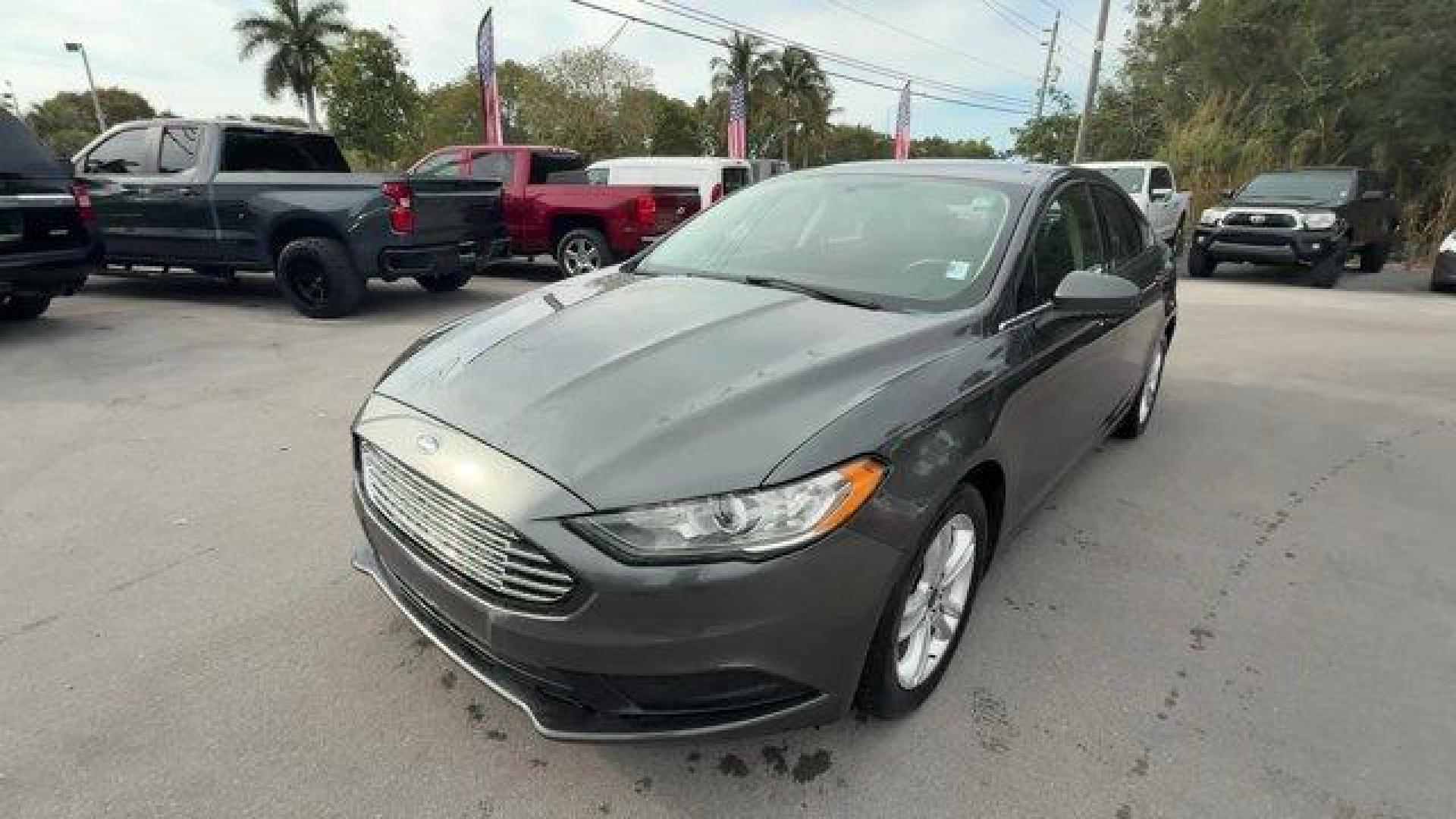 2018 Gray Ford Fusion (3FA6P0HD6JR) with an 4 1.5 L engine, Automatic transmission, located at 27610 S Dixie Hwy, Homestead, FL, 33032, (305) 749-2348, 25.510241, -80.438301 - KBB.com 10 Best Sedans Under $25,000. Scores 32 Highway MPG and 21 City MPG! This Ford Fusion delivers a Intercooled Turbo Regular Unleaded I-4 1.5 L/91 engine powering this Automatic transmission. ENGINE: 1.5L ECOBOOST -inc: Auto Stop-Start Technology, Wheels: 17 Sparkle Silver Painted Aluminum, Tr - Photo#0
