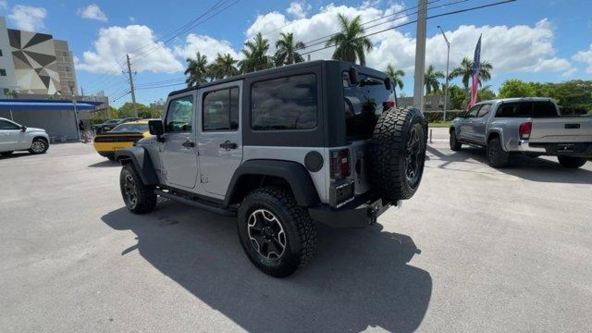2014 Billet Metallic Clearcoat /Black Jeep Wrangler Unlimited (1C4BJWDG7EL) with an 6 3.6 L engine, Automatic transmission, located at 27610 S Dixie Hwy, Homestead, FL, 33032, (305) 749-2348, 25.510241, -80.438301 - Only 94,538 Miles! Scores 20 Highway MPG and 16 City MPG! This Jeep Wrangler Unlimited boasts a Regular Unleaded V-6 3.6 L/220 engine powering this Automatic transmission. SIRIUS SATELLITE RADIO (subscription required), ENGINE: 3.6L V6 24V VVT (STD), ANTI-SPIN DIFFERENTIAL REAR AXLE.*This Jeep Wrang - Photo#2