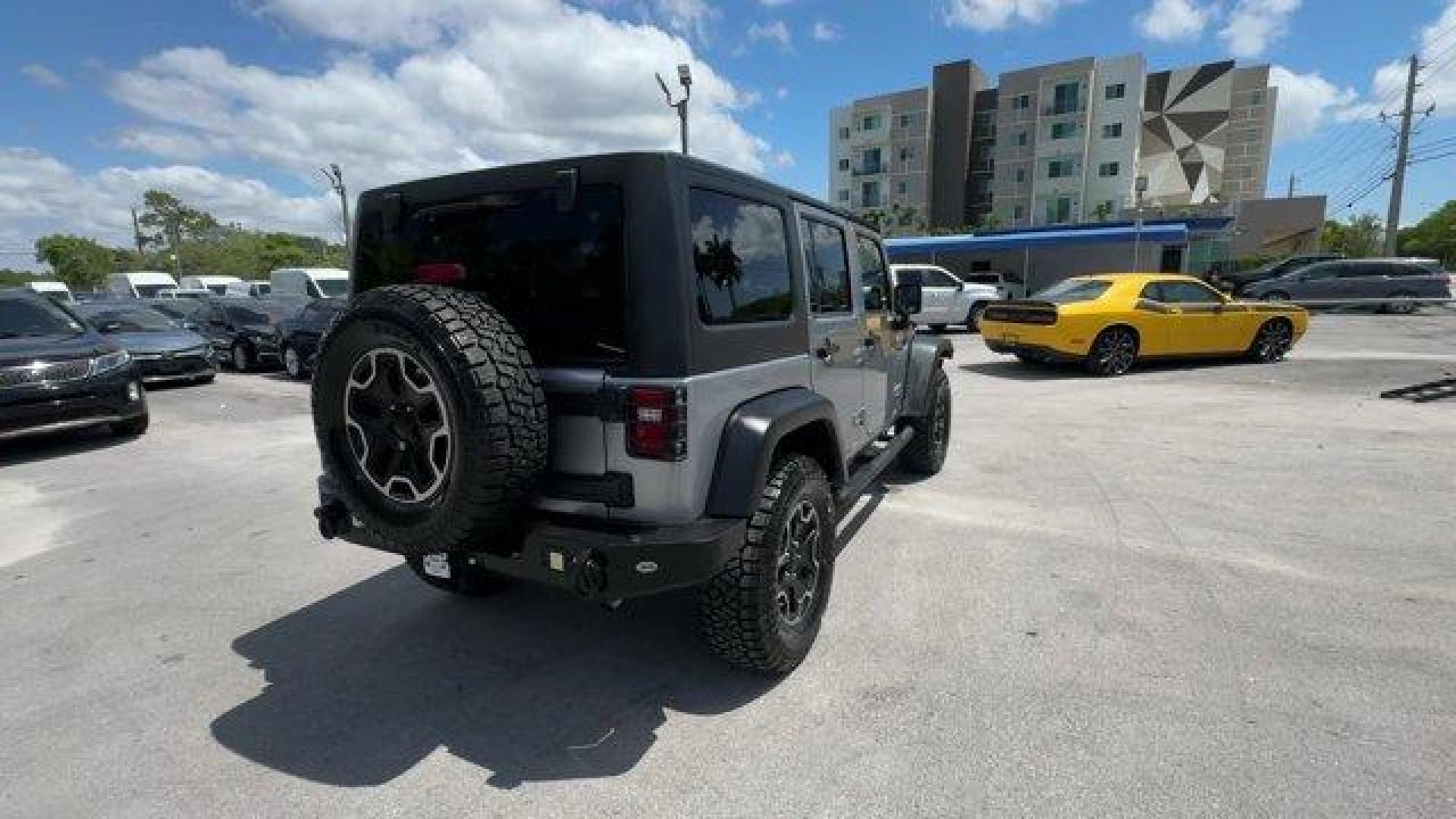 2014 Billet Metallic Clearcoat /Black Jeep Wrangler Unlimited (1C4BJWDG7EL) with an 6 3.6 L engine, Automatic transmission, located at 27610 S Dixie Hwy, Homestead, FL, 33032, (305) 749-2348, 25.510241, -80.438301 - Only 94,538 Miles! Scores 20 Highway MPG and 16 City MPG! This Jeep Wrangler Unlimited boasts a Regular Unleaded V-6 3.6 L/220 engine powering this Automatic transmission. SIRIUS SATELLITE RADIO (subscription required), ENGINE: 3.6L V6 24V VVT (STD), ANTI-SPIN DIFFERENTIAL REAR AXLE.*This Jeep Wrang - Photo#4