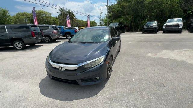 2016 Blue Honda Civic Sedan (19XFC1F36GE) with an 4 1.5 L engine, Variable transmission, located at 27610 S Dixie Hwy, Homestead, FL, 33032, (305) 749-2348, 25.510241, -80.438301 - IIHS Top Safety Pick+. Scores 42 Highway MPG and 31 City MPG! This Honda Civic Sedan delivers a Intercooled Turbo Regular Unleaded I-4 1.5 L/91 engine powering this Variable transmission. Wheels: 17 Alloy, Wheels w/Silver Accents, VSA Electronic Stability Control (ESC).*This Honda Civic Sedan Comes - Photo#0