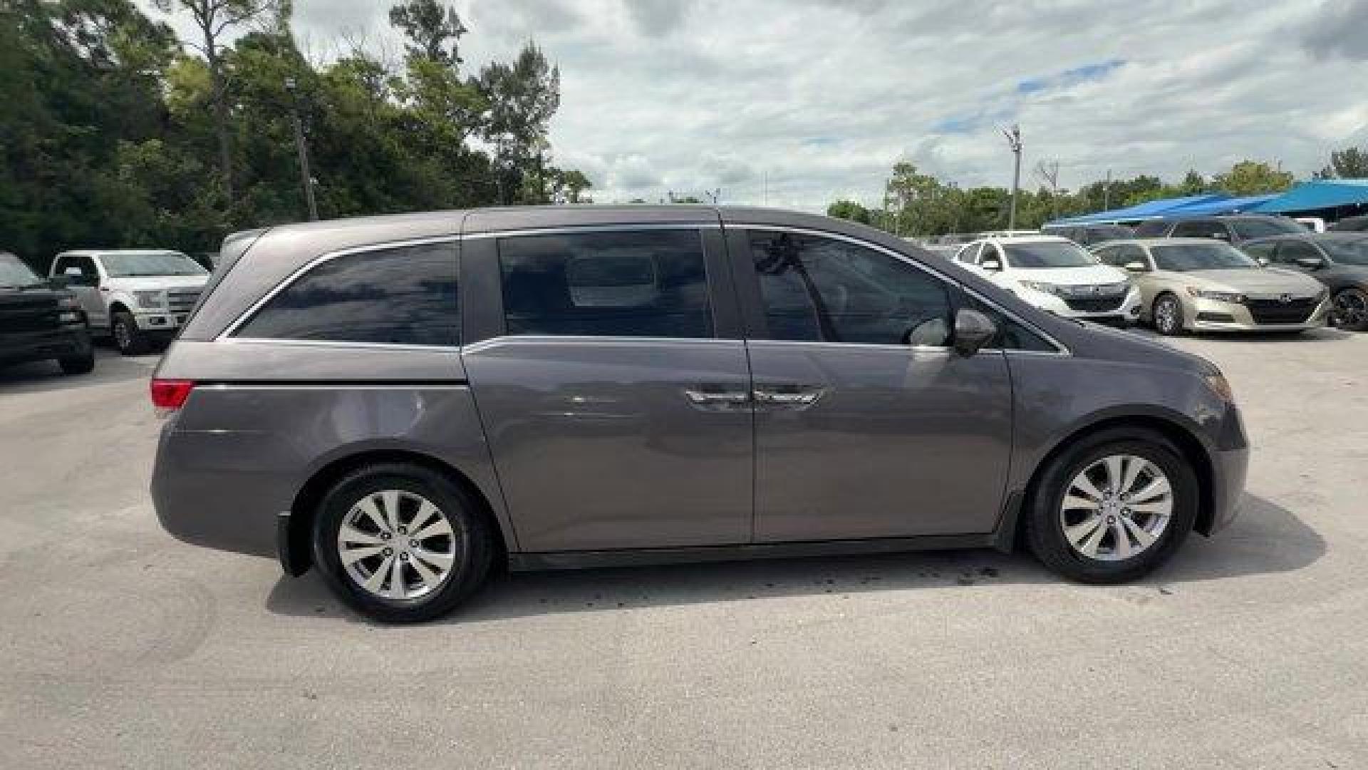 2014 Gray Honda Odyssey (5FNRL5H47EB) with an 6 3.5 L engine, Automatic transmission, located at 27610 S Dixie Hwy, Homestead, FL, 33032, (305) 749-2348, 25.510241, -80.438301 - IIHS Top Safety Pick+. Boasts 28 Highway MPG and 19 City MPG! This Honda Odyssey delivers a Regular Unleaded V-6 3.5 L/212 engine powering this Automatic transmission. Window Grid Antenna, Wheels: 17 x 7 Alloy, VSA Electronic Stability Control (ESC).*This Honda Odyssey Comes Equipped with These Opti - Photo#5