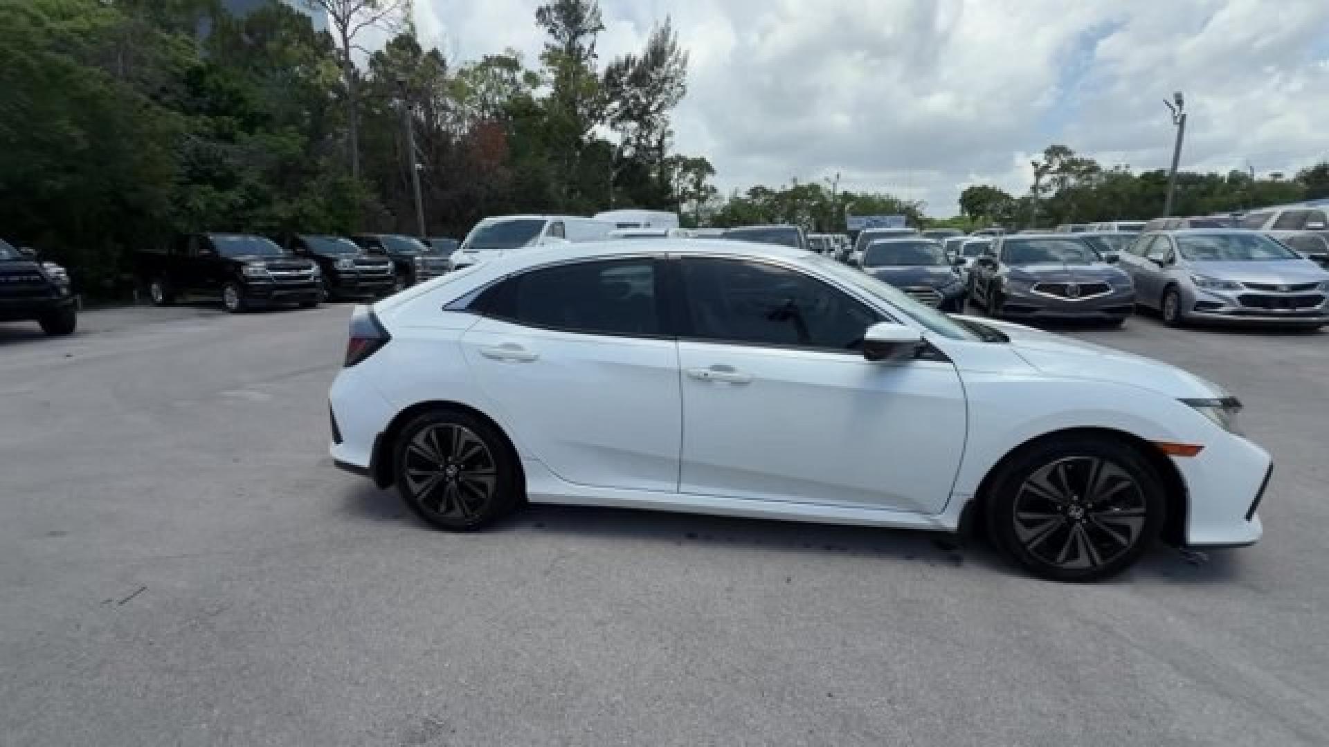 2018 White Honda Civic Hatchback (SHHFK7H51JU) with an 4 1.5 L engine, Variable transmission, located at 27610 S Dixie Hwy, Homestead, FL, 33032, (305) 749-2348, 25.510241, -80.438301 - KBB.com 10 Most Awarded Brands. Boasts 40 Highway MPG and 31 City MPG! This Honda Civic Hatchback boasts a Intercooled Turbo Regular Unleaded I-4 1.5 L/91 engine powering this Variable transmission. Wheels: 17 Alloy, Wheels w/Silver Accents, VSA Electronic Stability Control (ESC).*This Honda Civic H- Photo#5