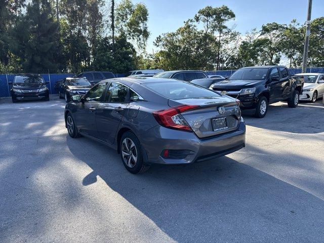 2017 Gray Honda Civic Sedan (19XFC2F56HE) with an 4 2.0 L engine, Variable transmission, located at 27610 S Dixie Hwy, Homestead, FL, 33032, (305) 749-2348, 25.510241, -80.438301 - IIHS Top Safety Pick. Boasts 40 Highway MPG and 31 City MPG! This Honda Civic Sedan delivers a Regular Unleaded I-4 2.0 L/122 engine powering this Variable transmission. Wheels: 16 w/Full Covers, VSA Electronic Stability Control (ESC), Valet Function.*This Honda Civic Sedan Comes Equipped with These - Photo#2