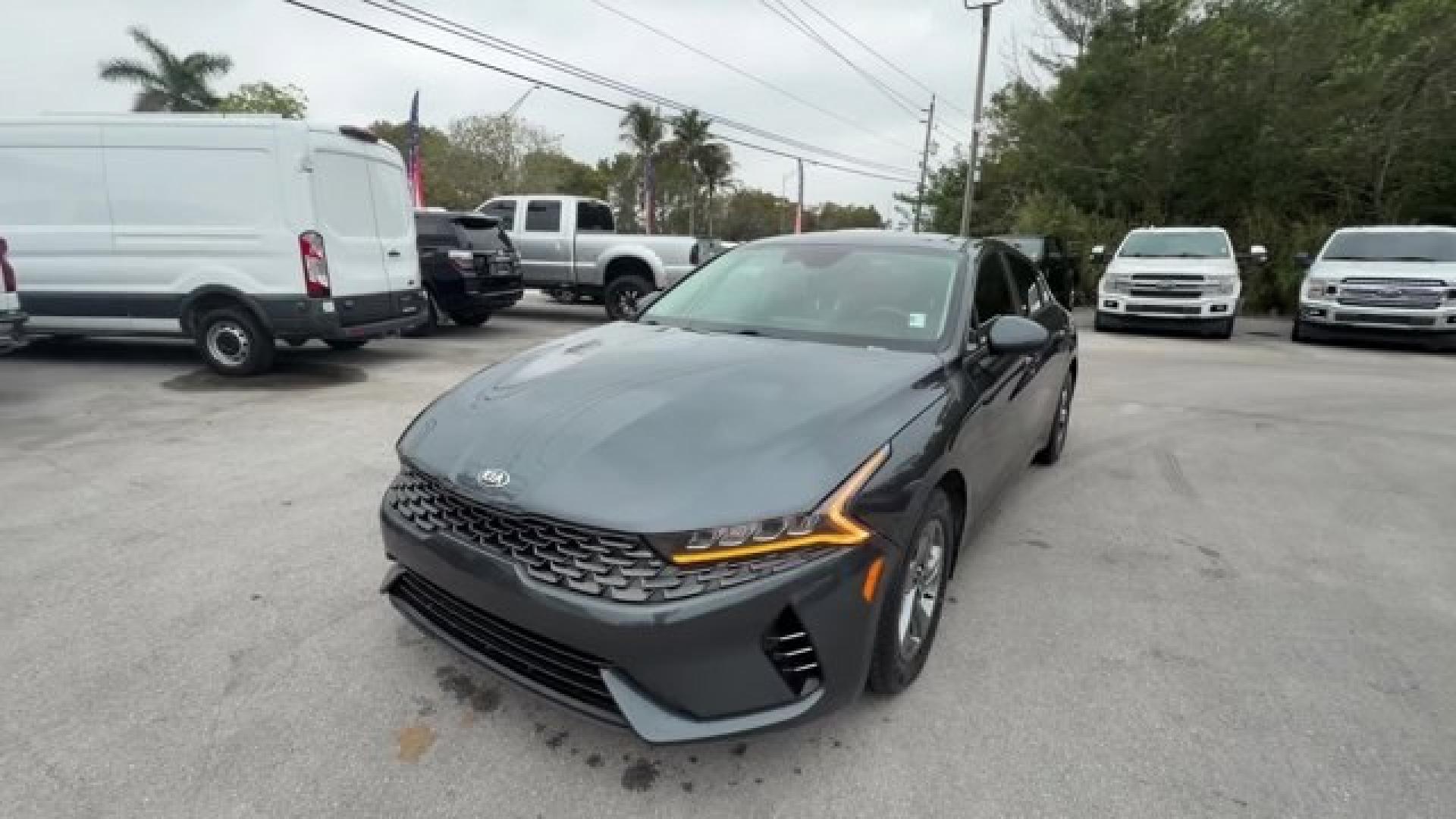 2021 Gravity Gray /Black Kia K5 (5XXG14J25MG) with an 4 1.6 L engine, Automatic transmission, located at 27610 S Dixie Hwy, Homestead, FL, 33032, (305) 749-2348, 25.510241, -80.438301 - Delivers 37 Highway MPG and 27 City MPG! This Kia K5 boasts a Intercooled Turbo Regular Unleaded I-4 1.6 L/98 engine powering this Automatic transmission. CARPETED FLOOR MATS, BLACK, CLOTH SEAT TRIM, Wireless Phone Connectivity.* This Kia K5 Features the Following Options *Window Grid Antenna, Wheel - Photo#0