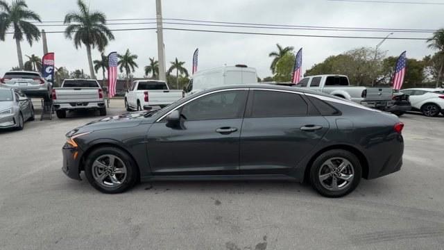 2021 Gravity Gray /Black Kia K5 (5XXG14J25MG) with an 4 1.6 L engine, Automatic transmission, located at 27610 S Dixie Hwy, Homestead, FL, 33032, (305) 749-2348, 25.510241, -80.438301 - Delivers 37 Highway MPG and 27 City MPG! This Kia K5 boasts a Intercooled Turbo Regular Unleaded I-4 1.6 L/98 engine powering this Automatic transmission. CARPETED FLOOR MATS, BLACK, CLOTH SEAT TRIM, Wireless Phone Connectivity.* This Kia K5 Features the Following Options *Window Grid Antenna, Wheel - Photo#1